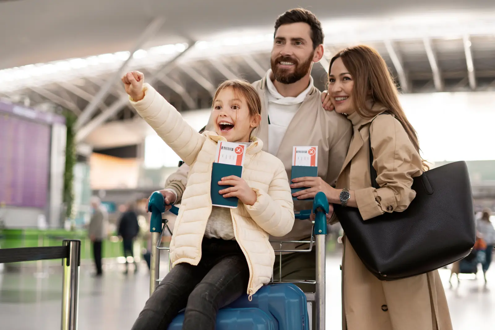 A happy family with their passports at an airport terminal